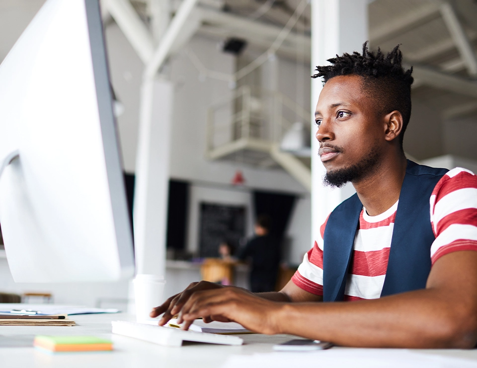 Man sits at computer and works